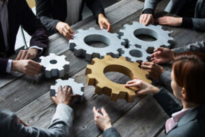 several team members working with cogs like puzzle pieces 303 Networks