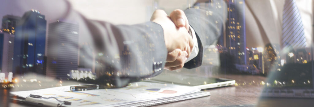 image of two partners shaking hands over a graph and iPad 303 Networks