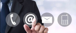 image showing man taping the @ symbol plus phone, email, and phone icons 303 Networks